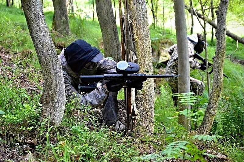 man in the woods playing paintball with a Woodsball gun