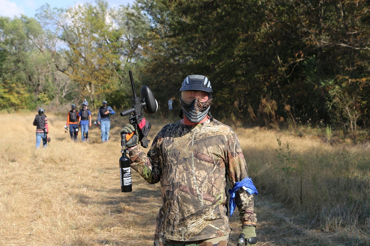 man holding a paintball gun with JT tactical marker